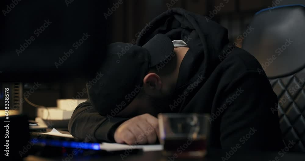 Young programmer sleeps on desk in front of computer at night, man fell asleep during night shift, hacking internet, programming website, tired work guy.