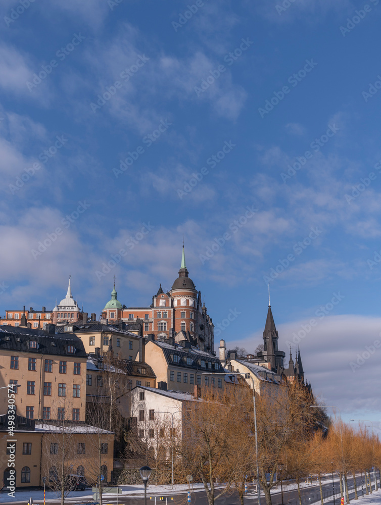 Block with old 1700s houses a snowy spring day in Stockholm