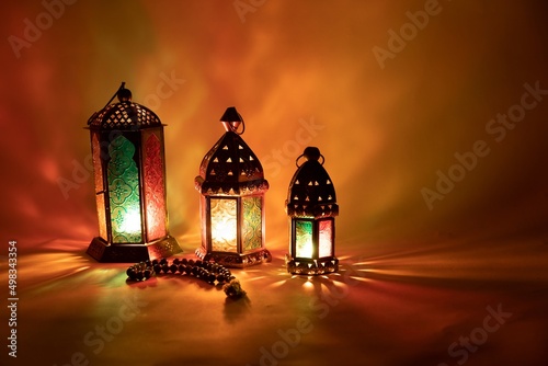 three arabic lantern with prayer beads in orange photo