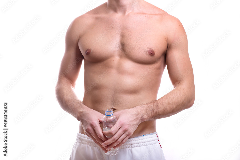 body of a young caucasian male athletic naked to the waist isolated on white background with a bottle of water in hand