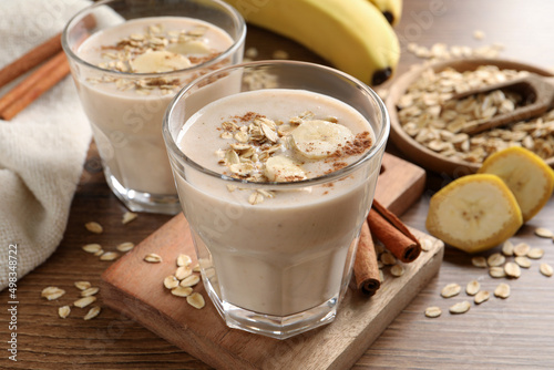 Tasty banana smoothie with oatmeal and cinnamon on wooden table