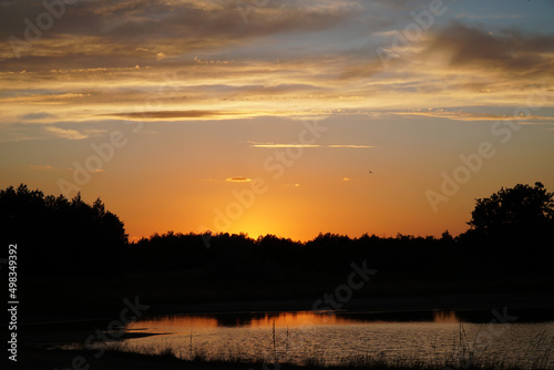 Beautiful sunset sky on the river © denys_kuvaiev