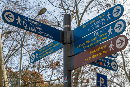 Street signs marking the direction to the famous sites to visit in Barcelona, Spain