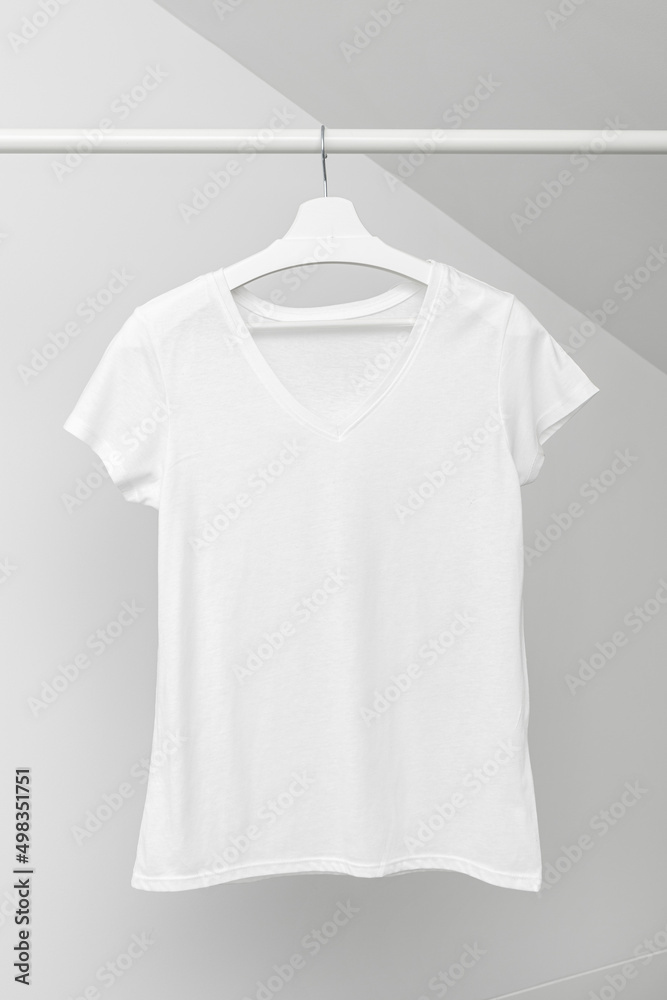 Group of Assorted t-shirts hanging on white hangers. Clothing rack Group of Assorted t-shirts hanging on white hangers. Clothing rack