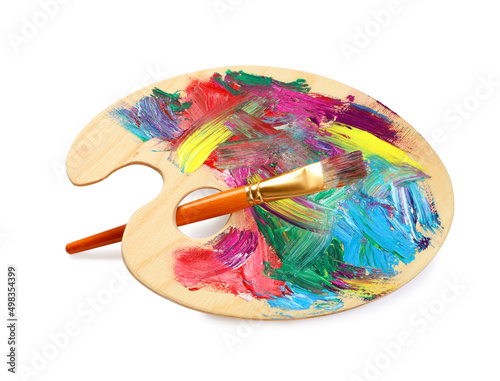 Wooden artist's palette with mixed paints and brush isolated on white
