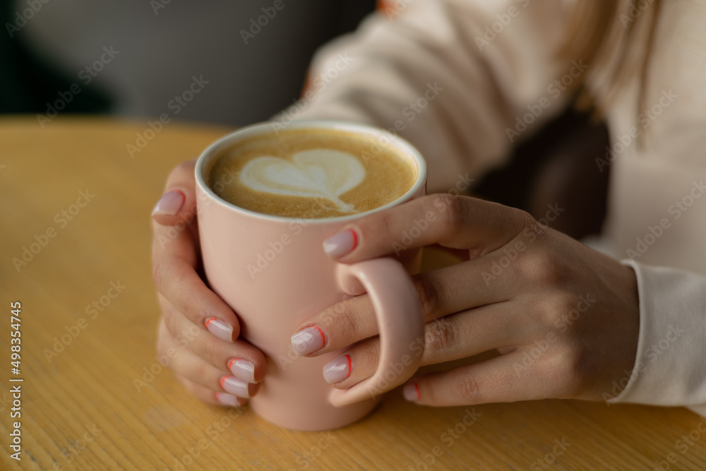 a girl drink coffee in a cafe