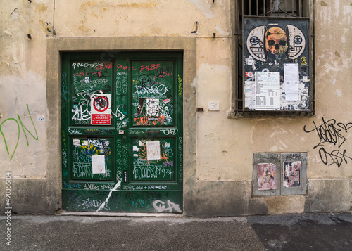 old door and graffiti and street art in old town Florence, Italy 