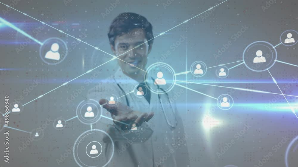 Animation of network of connections with people icons over caucasian male doctor Animation of network of connections with people icons over caucasian male doctor