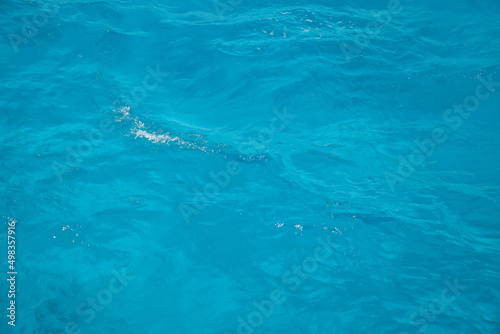 Abstract background. Waves of blue sea water. Copy space. Selective focus.