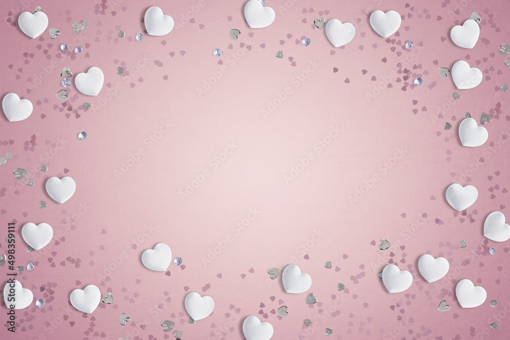 White fabric love hearts and table decorations on a pink background with copy space