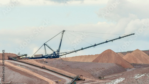 Giant spreader or absetzer machinery. A large dumper on a landfill with potash ore. Extracting potassium salts.