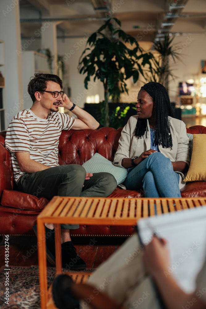 Angry couple argue in therapy. Dispute in marriage counseling. Angry couple argue in therapy. Dispute in marriage counseling.