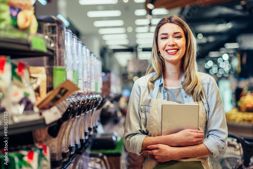 Confident young owner standing in a grocery store