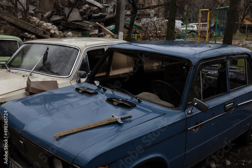 A car with broken windows and a toy sword in a housing area bombed by the Russian army in Bodoryanca Ukraine