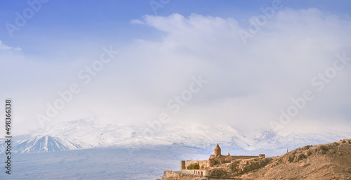 Panoramic banner of Khor virap monastery against snowy mountain of Ararat. Banner with place for text © piksik
