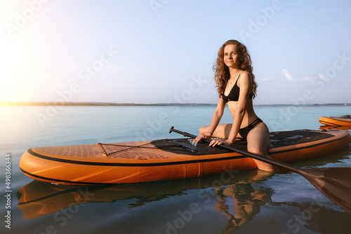 attractive young woman relaxes sitting on the SAP board . © yurolaitsalbert