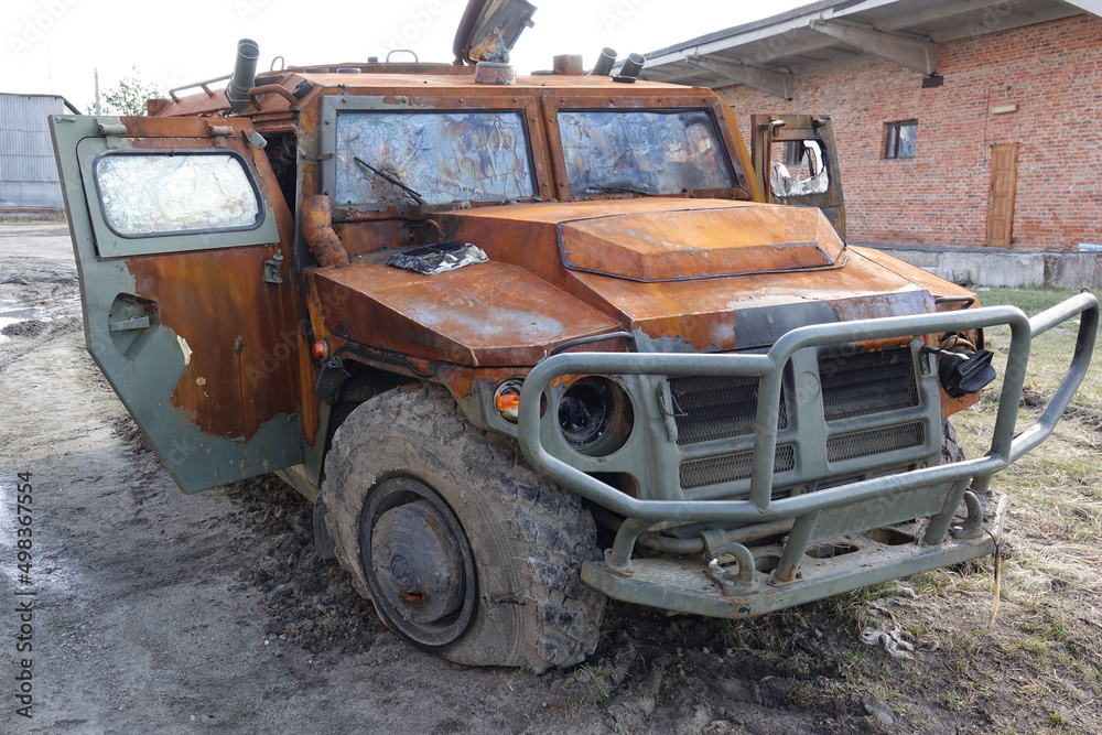 Fototapeta premium Military armored vehicles blown up and burned down on the street. Russian military vehicle 