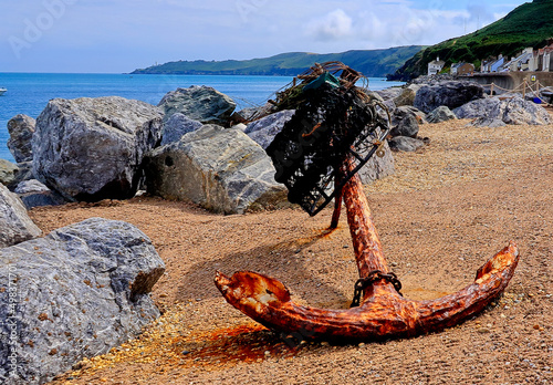 An old rusty anchor on the pebbled beach at Beesands photo