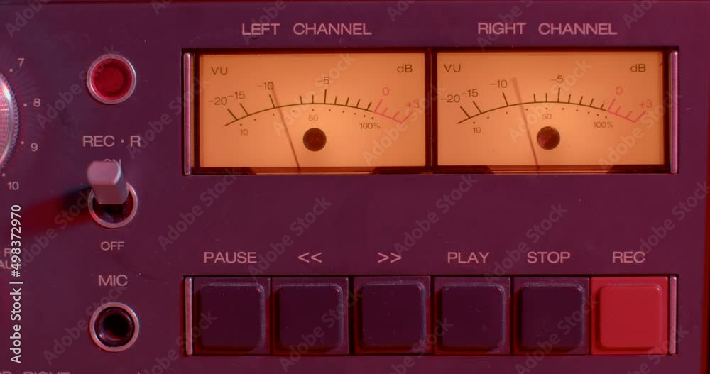 Close-up of hand turns on and off electronic classic analoge volume indicator. Needles moving from music sound. Monitor status of professional studio equipment. Close-up of hand turns on and off electronic classic analoge volume indicator. Needles moving from music sound. Monitor status of professional studio equipment.