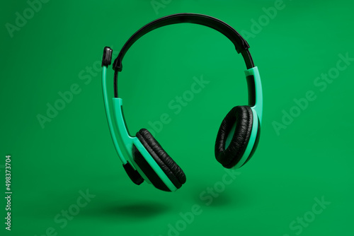 green headphones on green background 