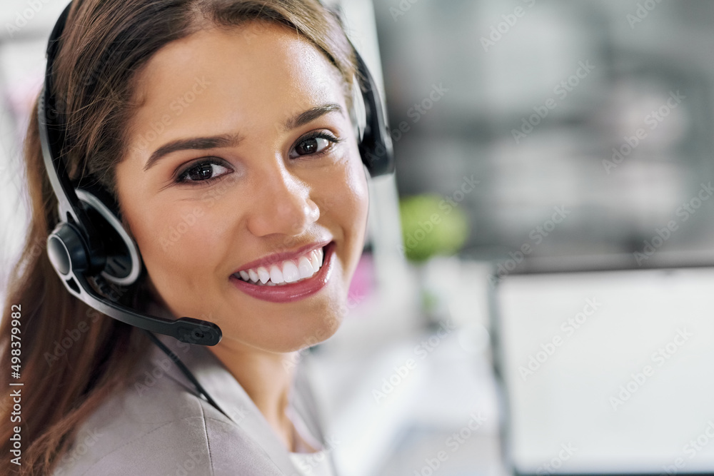 Quality service is my main aim. Portrait of a young call centre agent working in an office. Quality service is my main aim. Portrait of a young call centre agent working in an office.
