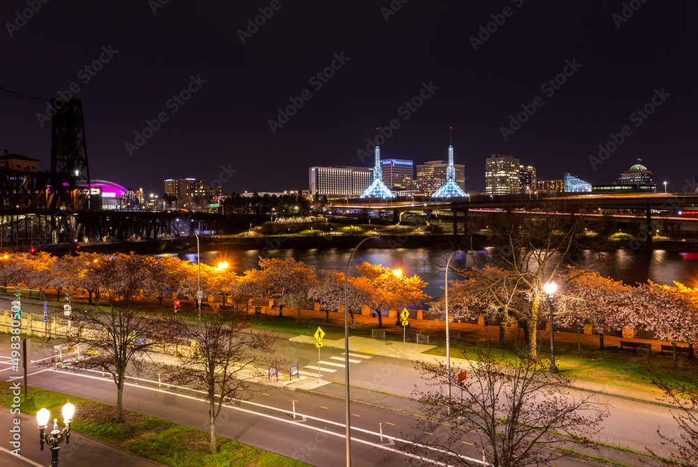 Fototapeta premium Portland, Oregon, cityscape in blooming season. Night lights reflect in Willamette River