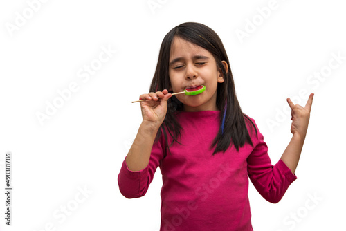 Fototapeta Naklejka Na Ścianę i Meble -  Little girl enjoying while eating candy on white background