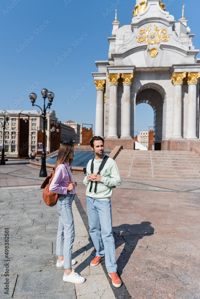 Young tourists with backpacks standing on urban street. Young tourists with backpacks standing on urban street.