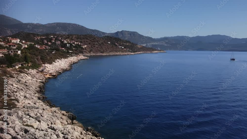 Aerial view of the coastline and Mediterranean sea in kas turkey at summer day. Drone footage of city situated on the shore and mountains on the background. Vacations next to ocean. Travel destination Aerial view of the coastline and Mediterranean sea in kas turkey at summer day. Drone footage of city situated on the shore and mountains on the background. Vacations next to ocean. Travel destination