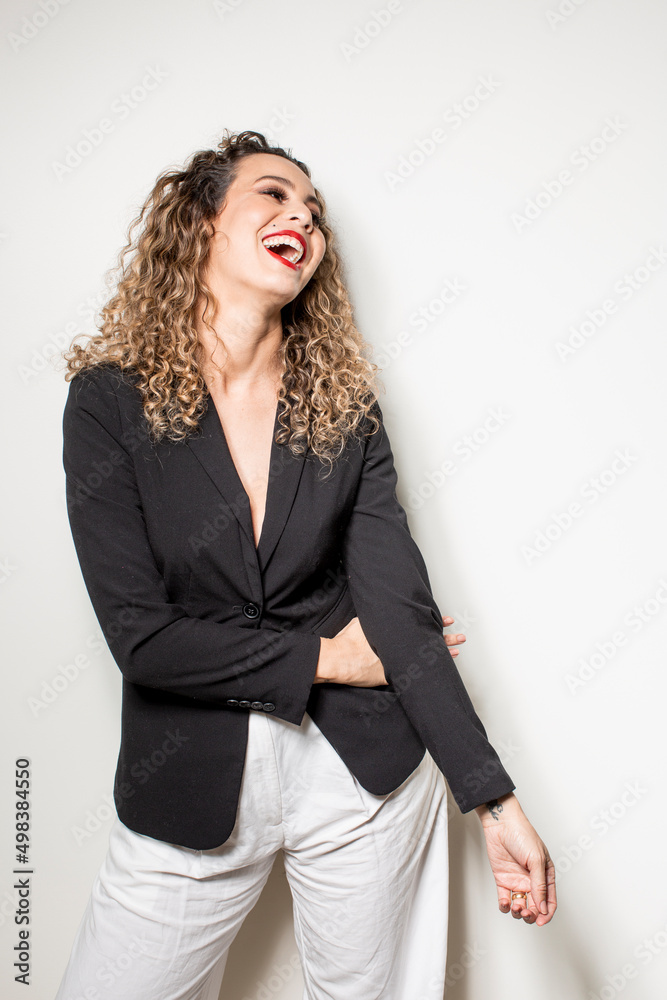 Studio shot of proud young girl with perfect light brown skin and beautiful curly hair in empowerment pose on a white background. Studio shot of proud young girl with perfect light brown skin and beautiful curly hair in empowerment pose on a white background.