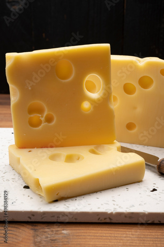Swiss cheese collection, yellow emmentaler cheese with round holes