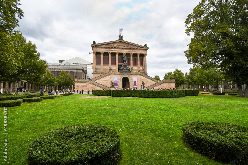 Fototapeta premium Tourists visit the National Gallery or Altes Nationalgalerie on an overcast day on Museum Island in Berlin Germany.