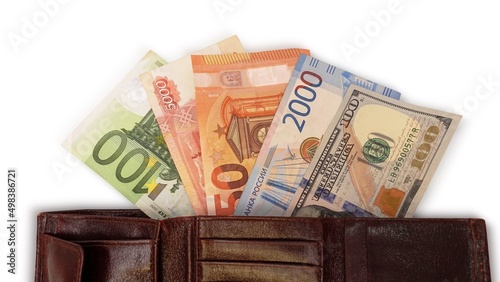 Top view of an open wallet with money. Close-up of a multi-currency wallet. Euro, dollar, ruble banknotes isolated on white background.Cash. The concept of financial literacy and savers