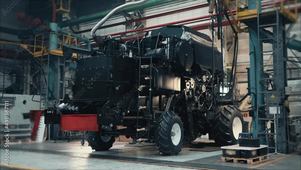 Agricultural combine in process of assembly on conveyor line in factory. Agricultural combine in process of assembly on conveyor line in factory.