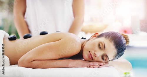 These stones will work out all your tension. Shot of a young woman getting a hot stone massage at a spa.