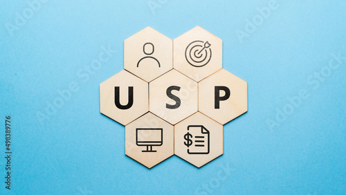 Acronym USP or Unique Selling Proposition. Abstract icons and text on wooden forms photo