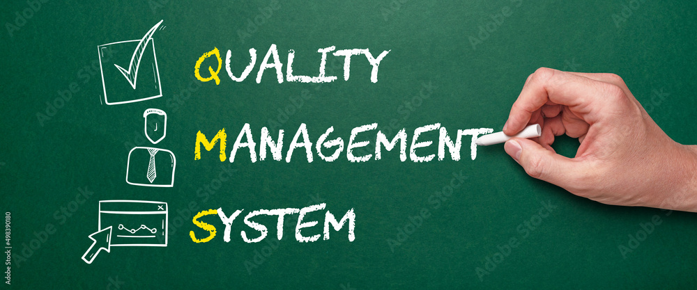 Acronym QMS or Quality Management System. Person with chalk writes text with icons Acronym QMS or Quality Management System. Person with chalk writes text with icons