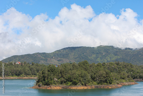 view of small island in the river with mountains
