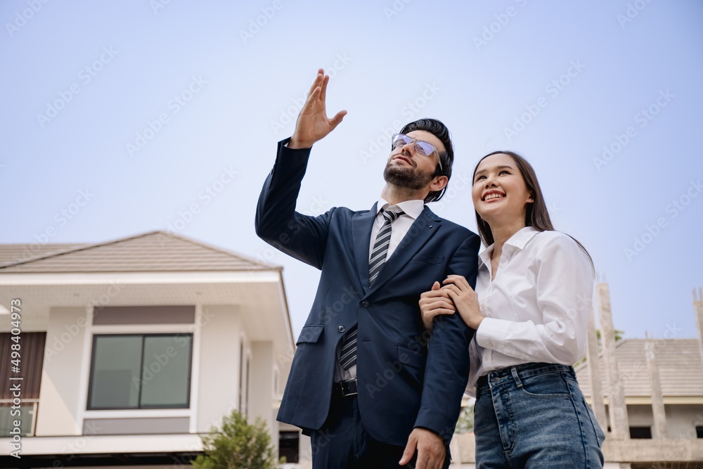Portrait of interracial couple. Beautiful face.Handsome businessman wearing a suit. Looking home to build a family.Middle Eastern and Asian looking house to rent.Planning to build a family,dream home. Portrait of interracial couple. Beautiful face.Handsome businessman wearing a suit. Looking home to build a family.Middle Eastern and Asian looking house to rent.Planning to build a family,dream home.