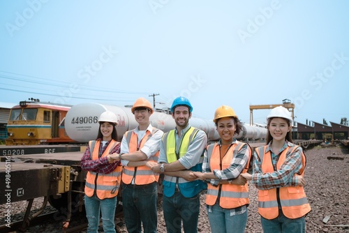 Group of multi-ethnic engineers shake hands at a train station. To display the teamwork symbol,gender equality,skin color.Effective coordination,cooperation, achievements,campaigns,wearing PPE,Diverse