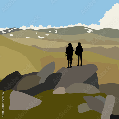 Man and woman hiking in the mountains looking into the landscape