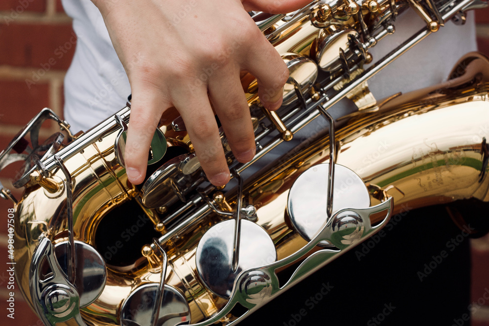 Fototapeta premium hands of a person playing the saxophone