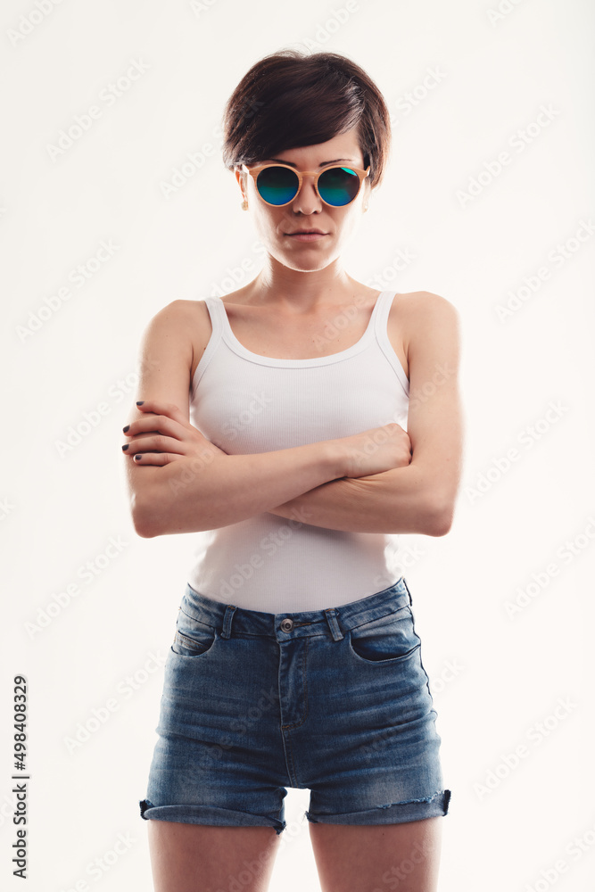 Trendy modern young woman with circular sunglasses or shades - obrazy, fototapety, plakaty 