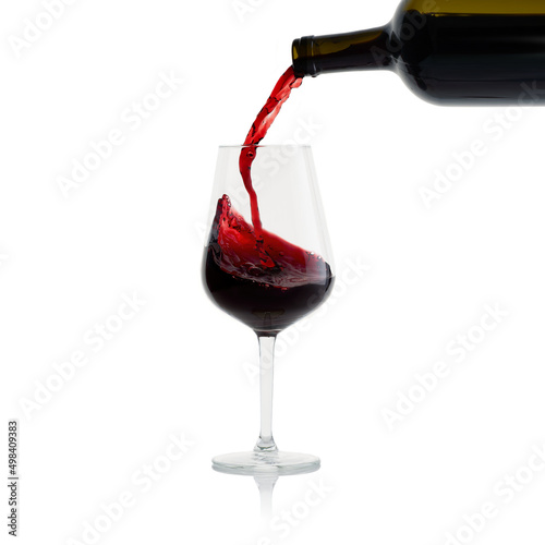 Tasty Red Wine with splash in glass isolated on white background.