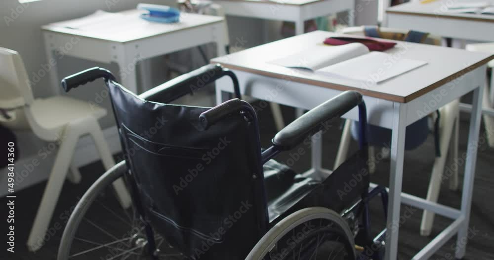 Video of empty wheelchair standing at desk in classroom