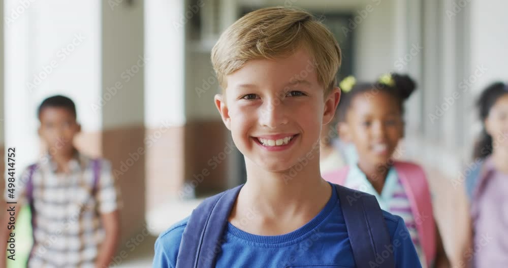 Video of happy caucasian boy standing at school corridor Video of happy caucasian boy standing at school corridor