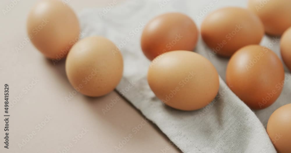 Video of close up of eggs and on rustic cloth on beige background Video of close up of eggs and on rustic cloth on beige background