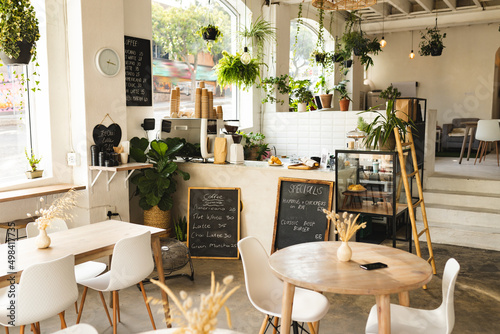 Interior of modern coffee shop with tables and chairs
