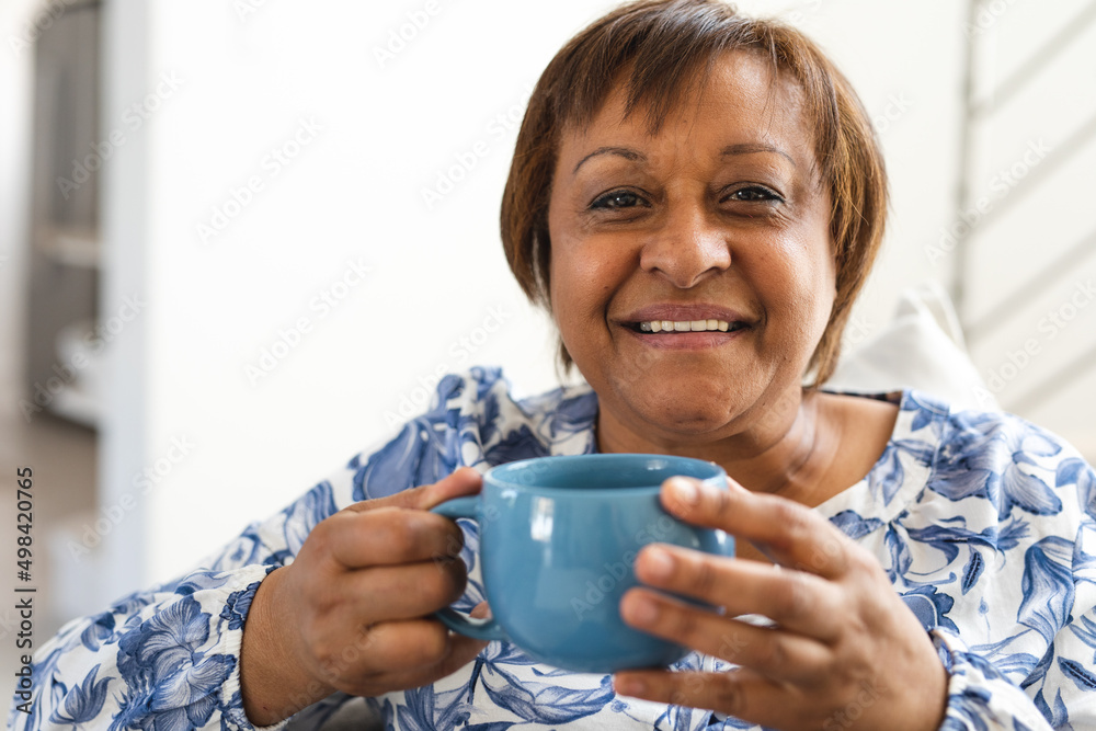 Portrait of smiling african american senior woman having coffee at home Portrait of smiling african american senior woman having coffee at home
