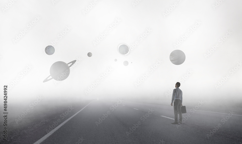 Back view of young businessman while standing with mist space background Back view of young businessman while standing with mist space background